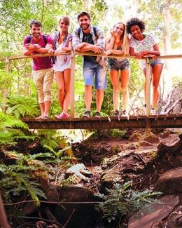 Students standing over a river